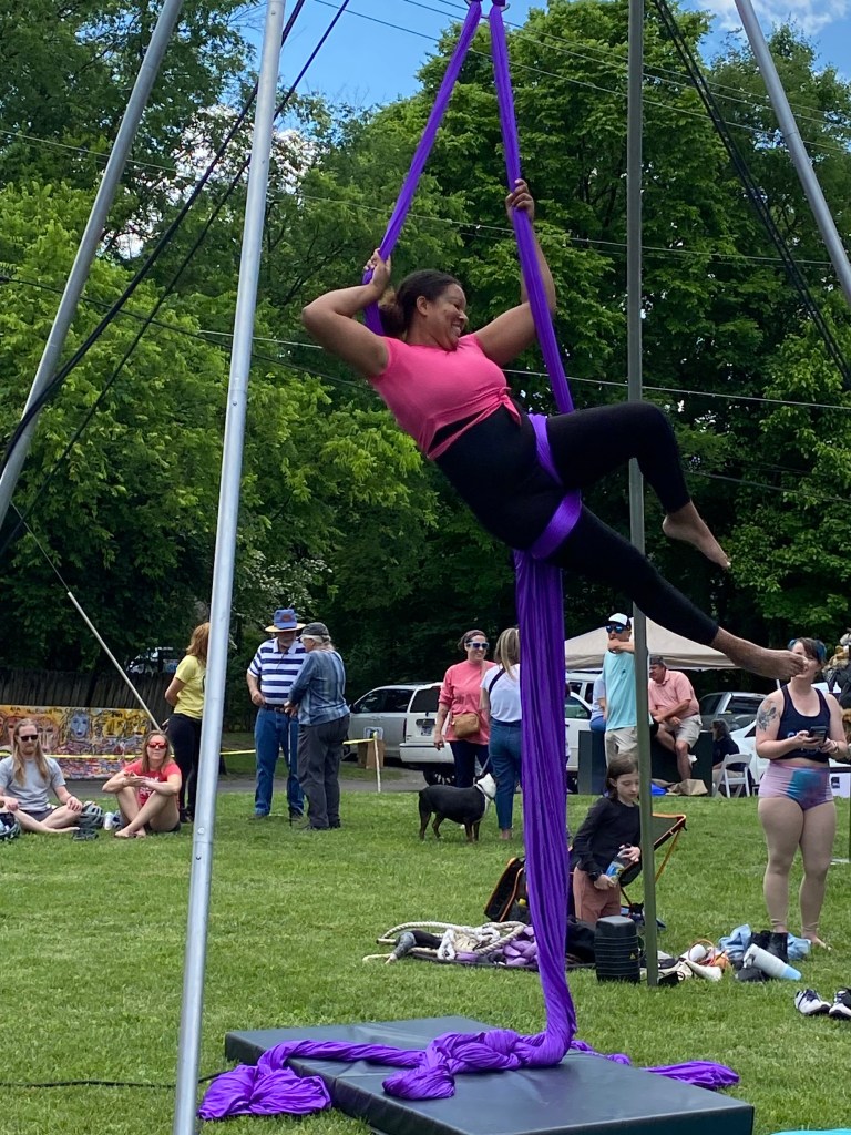 a Dragonfly Circus performer performs suspended above the ground